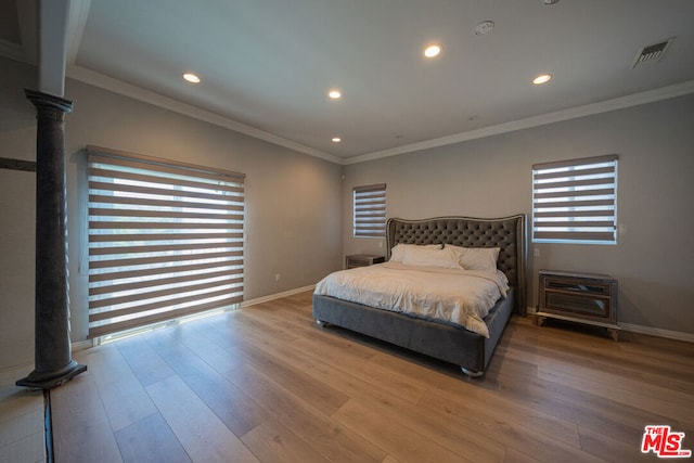 bedroom featuring wood-type flooring and crown molding