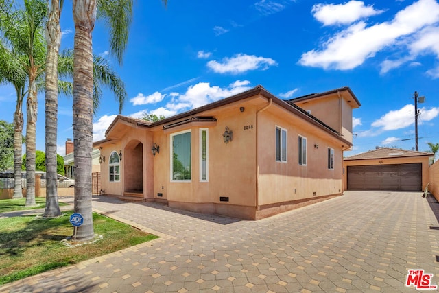 view of side of property featuring a garage and an outdoor structure