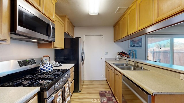 kitchen featuring light hardwood / wood-style floors, sink, and appliances with stainless steel finishes