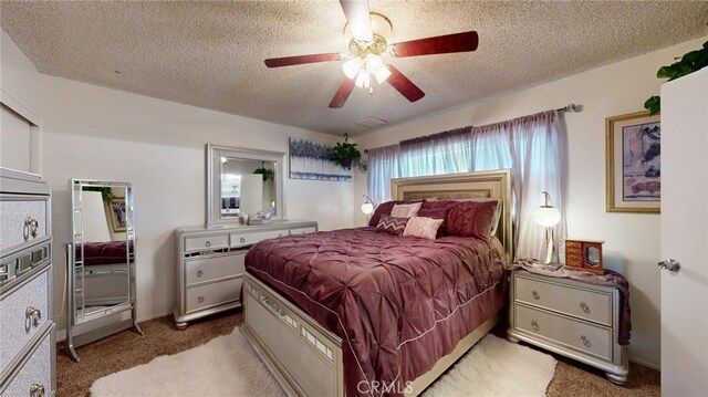 carpeted bedroom with a textured ceiling and ceiling fan