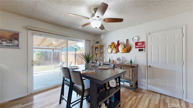 dining space with a textured ceiling, light hardwood / wood-style flooring, and ceiling fan