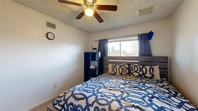 bedroom featuring ceiling fan, carpet, and a textured ceiling