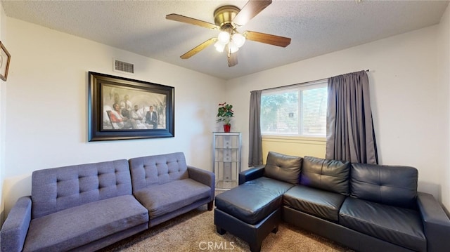 living room with ceiling fan, carpet, and a textured ceiling