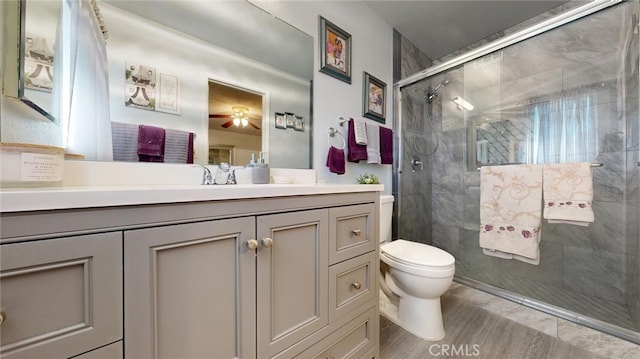 bathroom with vanity, toilet, and walk in shower