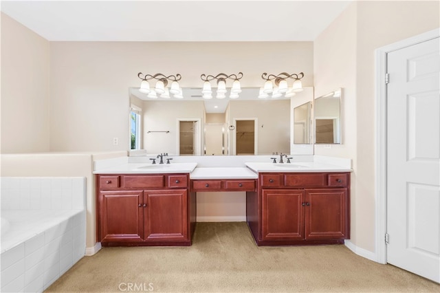 bathroom featuring vanity and tiled bath