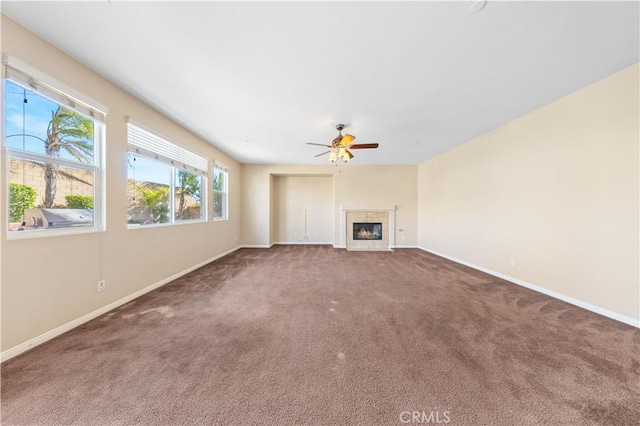 unfurnished living room with carpet flooring, ceiling fan, and a fireplace