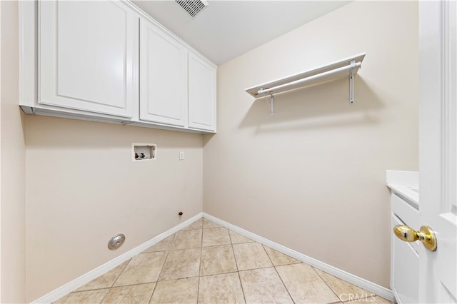 laundry area featuring washer hookup, gas dryer hookup, cabinets, and light tile patterned floors