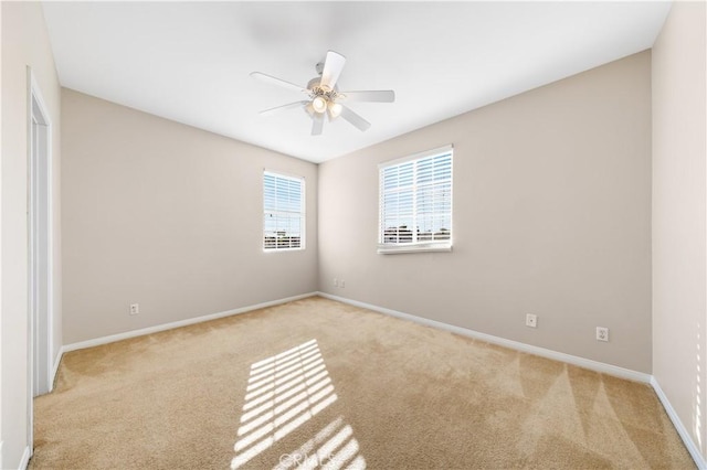 carpeted spare room with ceiling fan