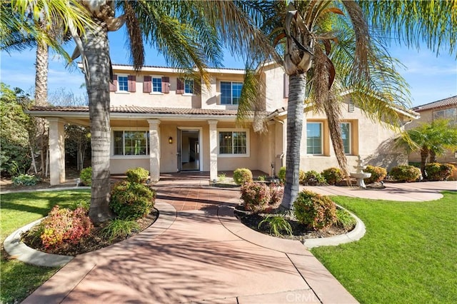 mediterranean / spanish house featuring a front lawn