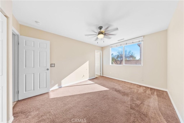 spare room featuring carpet and ceiling fan