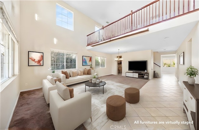 living room with a wealth of natural light, a towering ceiling, and light tile patterned floors