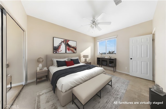 carpeted bedroom with ceiling fan and a closet