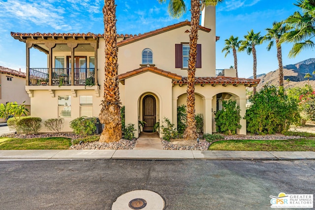 mediterranean / spanish-style house featuring a mountain view and a balcony