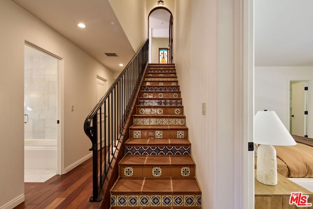 stairs with hardwood / wood-style flooring