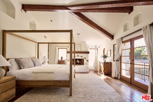 bedroom with beam ceiling, access to exterior, french doors, light hardwood / wood-style flooring, and high vaulted ceiling