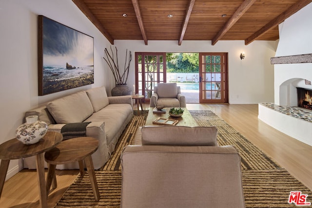 living room featuring a tiled fireplace, french doors, wooden ceiling, and light wood-type flooring