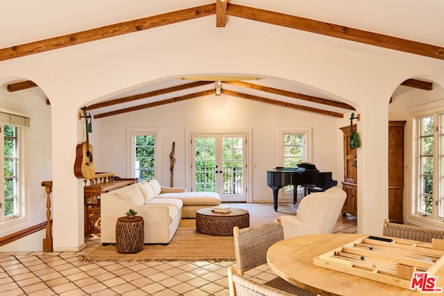 living room featuring lofted ceiling with beams and plenty of natural light