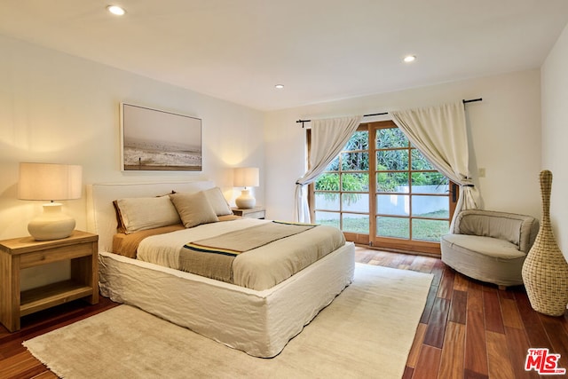 bedroom featuring dark hardwood / wood-style floors and access to outside