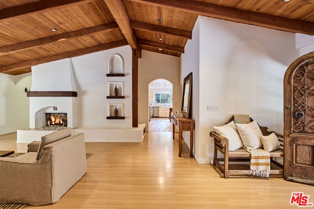 living room featuring wood ceiling, a large fireplace, high vaulted ceiling, beamed ceiling, and light hardwood / wood-style floors