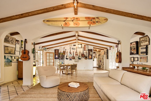 living room featuring light tile patterned floors, vaulted ceiling with beams, and a wealth of natural light