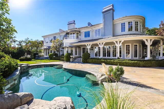 back of house with a balcony