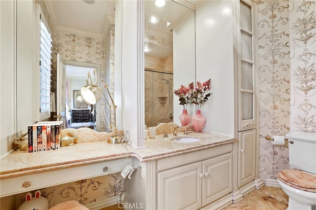 bathroom with vanity, toilet, a shower with shower door, and ornamental molding