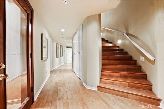 staircase with hardwood / wood-style floors