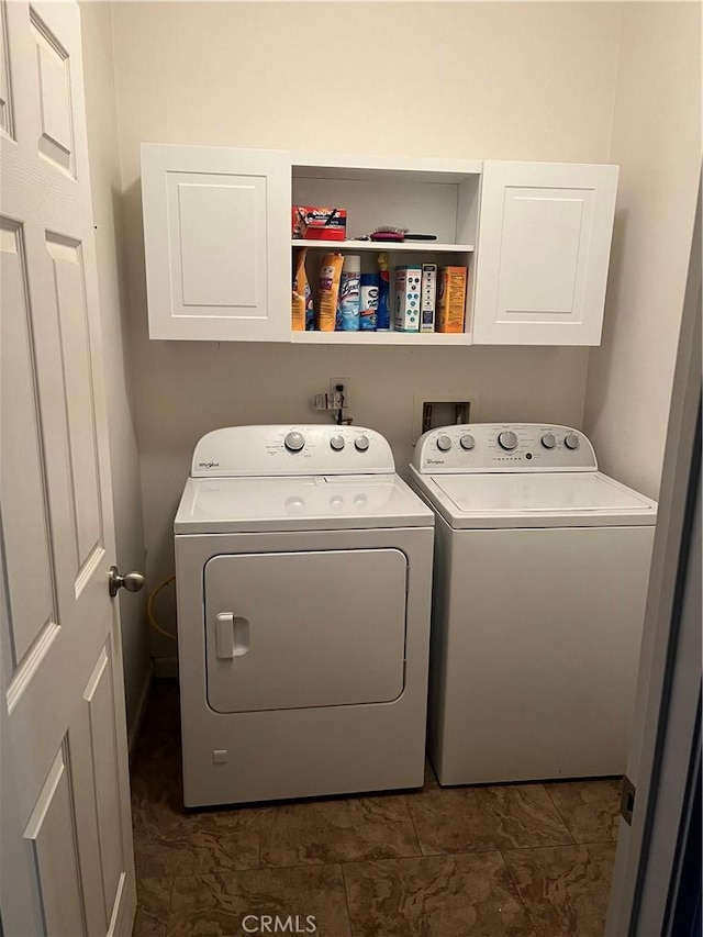 laundry room with cabinets and separate washer and dryer