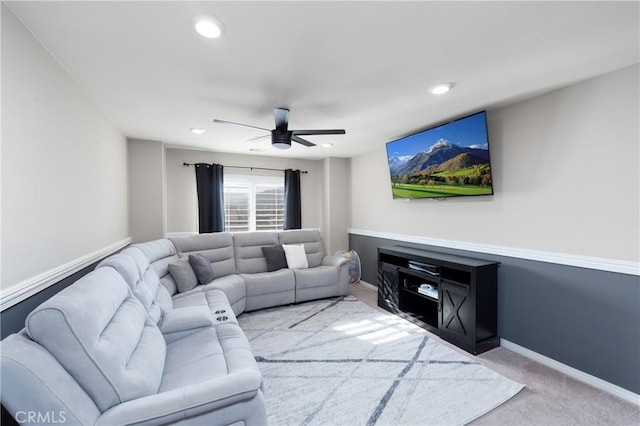 living room with ceiling fan and light colored carpet