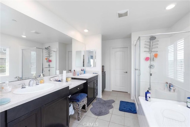 bathroom featuring tile patterned floors, vanity, and plus walk in shower