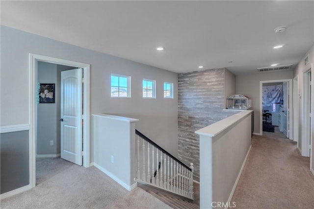 hallway with light colored carpet