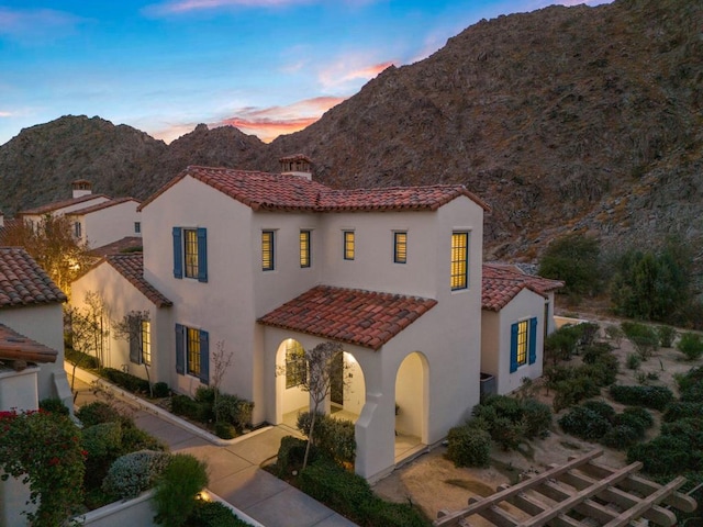 mediterranean / spanish-style house with a mountain view