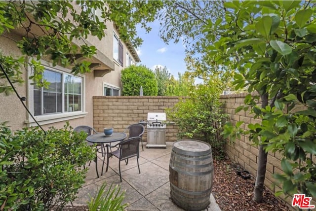 view of patio featuring a grill