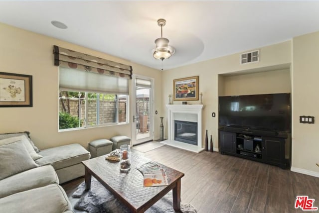 living room featuring dark hardwood / wood-style floors and ceiling fan