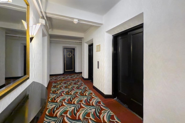 corridor featuring dark carpet