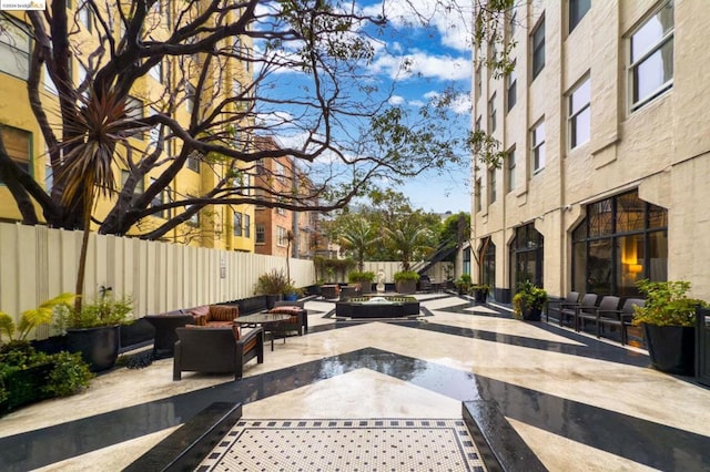 view of property's community with an outdoor hangout area and a patio area