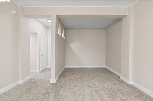 basement featuring light carpet