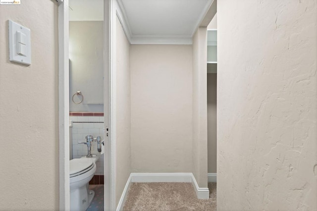 bathroom with tile walls and toilet