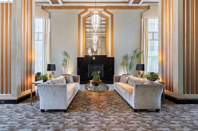 carpeted living room with a healthy amount of sunlight and an inviting chandelier