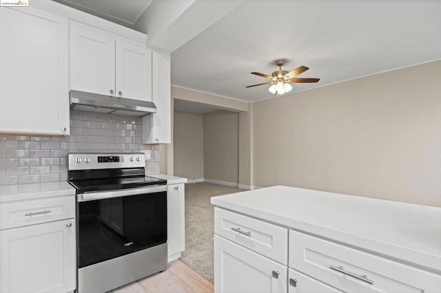 kitchen featuring white cabinets, decorative backsplash, and electric range