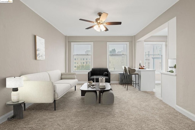 carpeted living room featuring ceiling fan