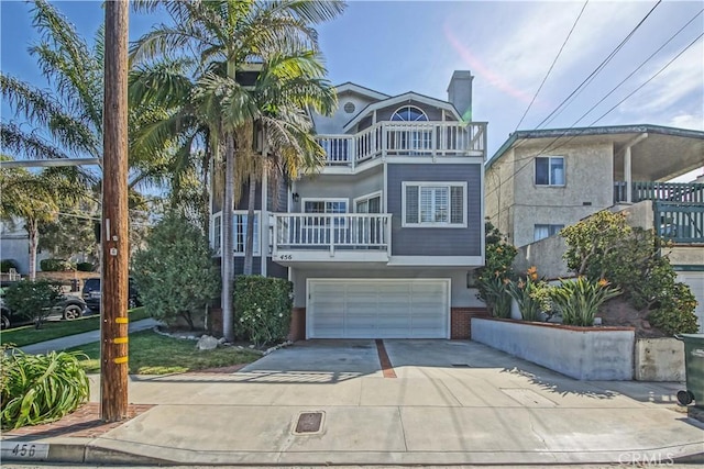 view of front of home with a balcony and a garage