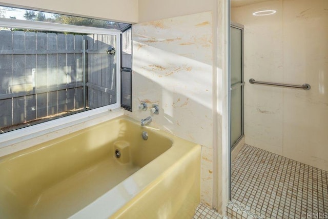 bathroom with a bathing tub and tile patterned flooring