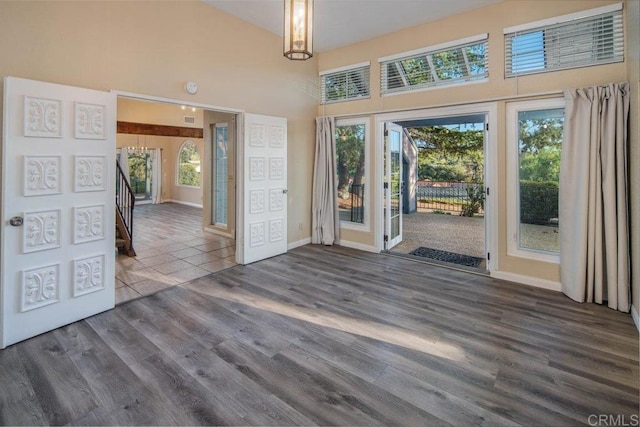 interior space with dark wood-type flooring and a high ceiling