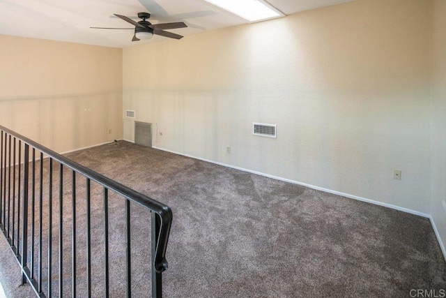 empty room with ceiling fan and carpet floors