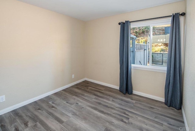 spare room with wood-type flooring