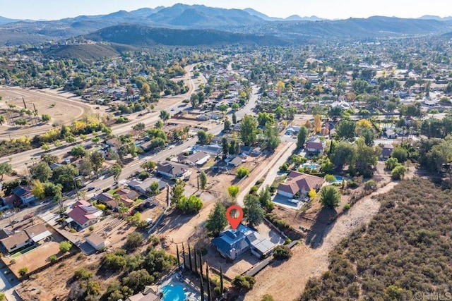 birds eye view of property featuring a mountain view