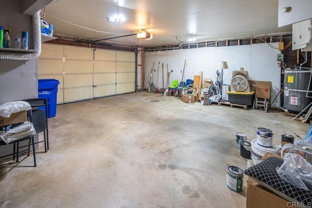 garage with a garage door opener and electric water heater