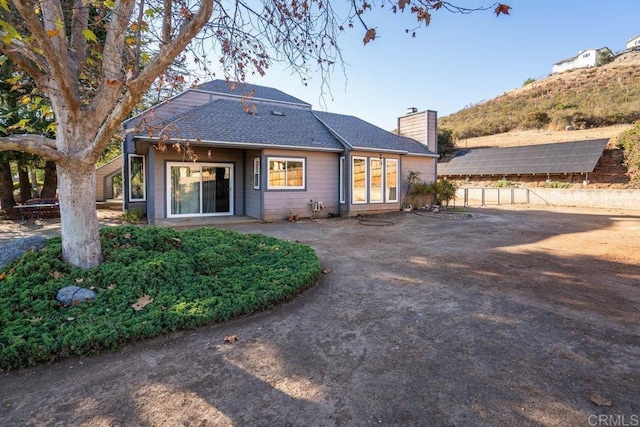 rear view of house with solar panels