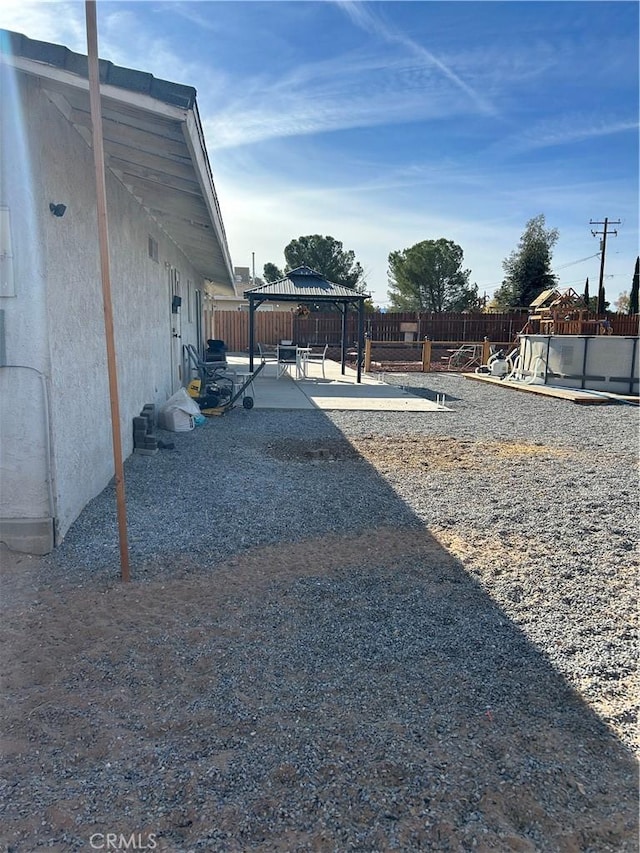 view of yard featuring a gazebo and a patio area